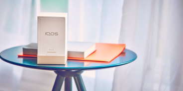 IQOS packaging on a glass table