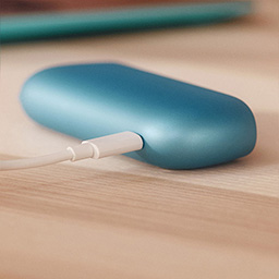Charging cord being inserted into IQOS device