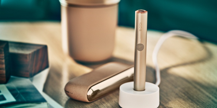An Azure Blue IQOS ILUMA device on the table.
