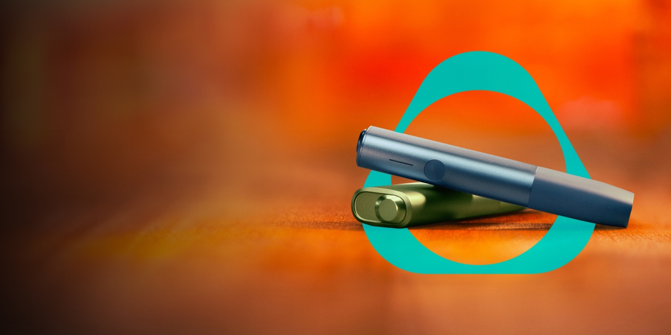 Green and blue IQOS devices placed in an IQOS logo on orange gradient background