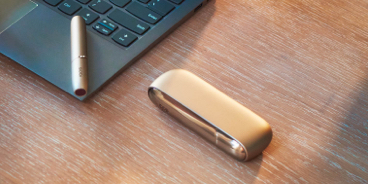 IQOS holder and charger on a laptop