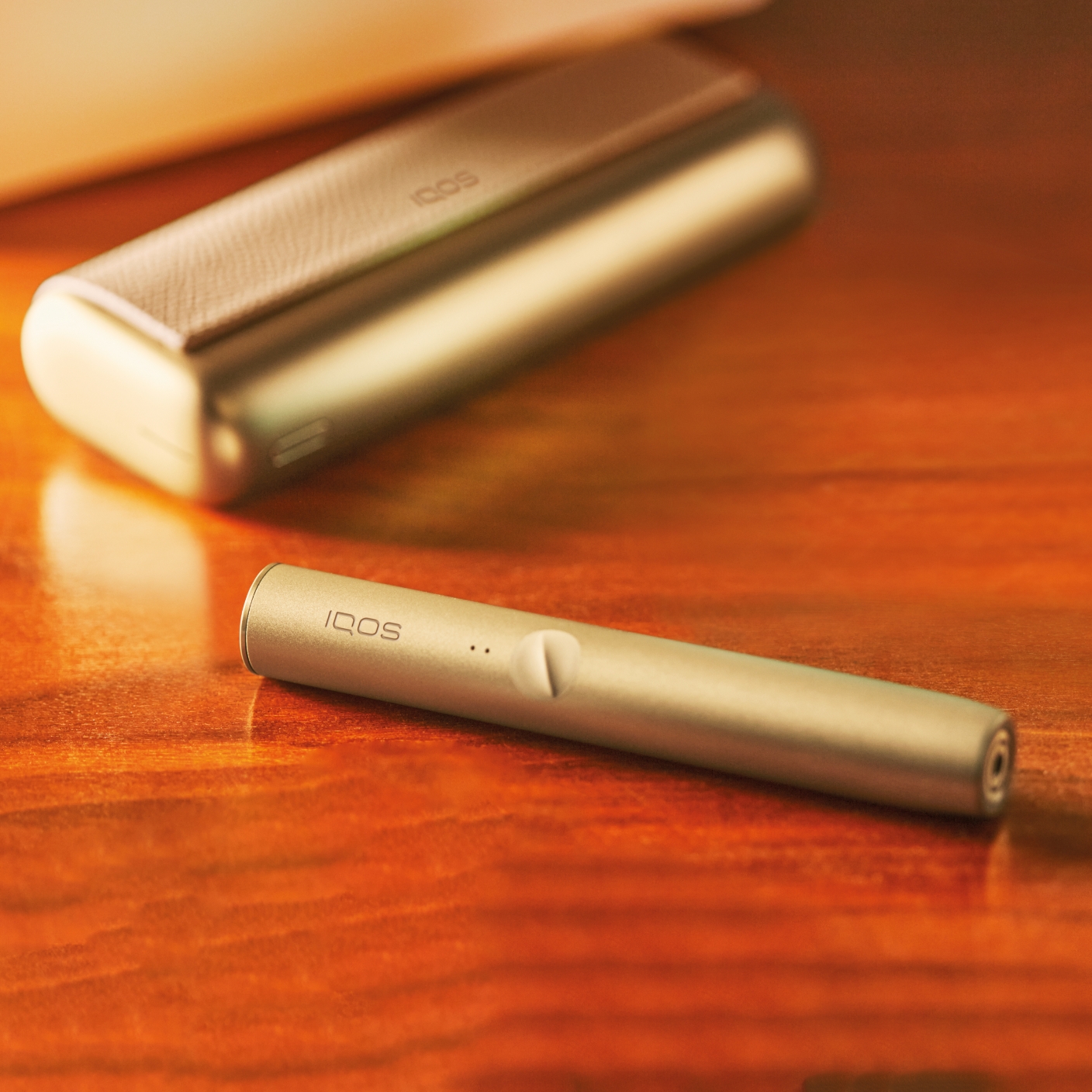 IQOS ILUMA PRIME device in gold khaki.