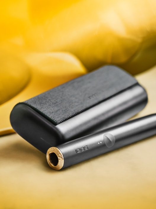 An IQOS ILUMA PRIME Holder and Pocket Charger