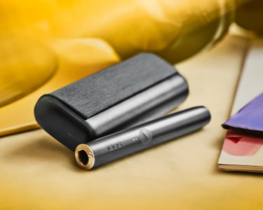 An IQOS ILUMA PRIME Holder and Pocket Charger