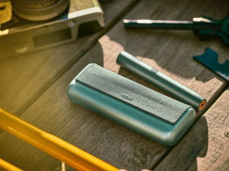 An IQOS ILUMA PRIME Holder and Pocket Charger.