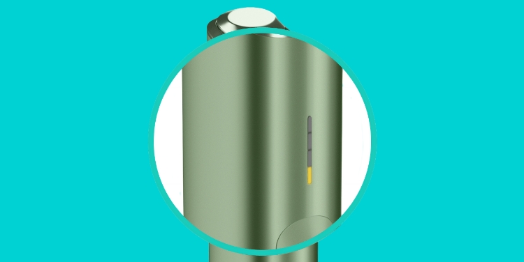 A close-up of one yellow light on IQOS ILUMA ONE device