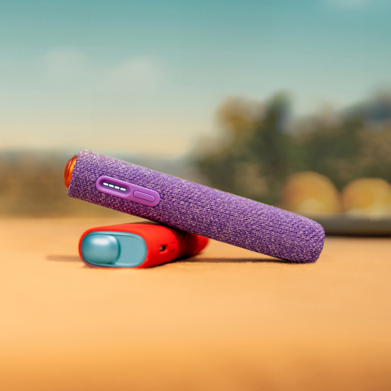 IQOS ILUMA i ONE device with violet sleeve above a red IQOS ILUMA i ONE