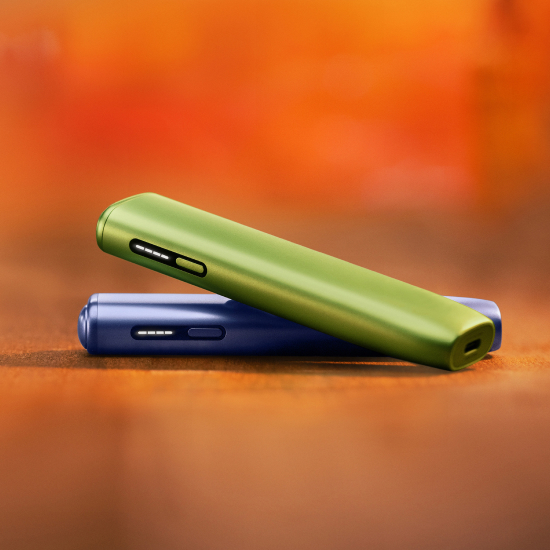 Green IQOS ILUMA i ONE above a violet IQOS ILUMA i ONE