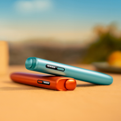 Blue IQOS ILUMA i ONE above a terracotta IQOS ILUMA i ONE