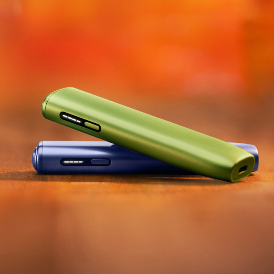 Green IQOS ILUMA i ONE above a violet IQOS ILUMA i ONE
