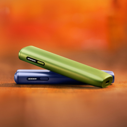 Green IQOS ILUMA i ONE above a violet IQOS ILUMA i ONE