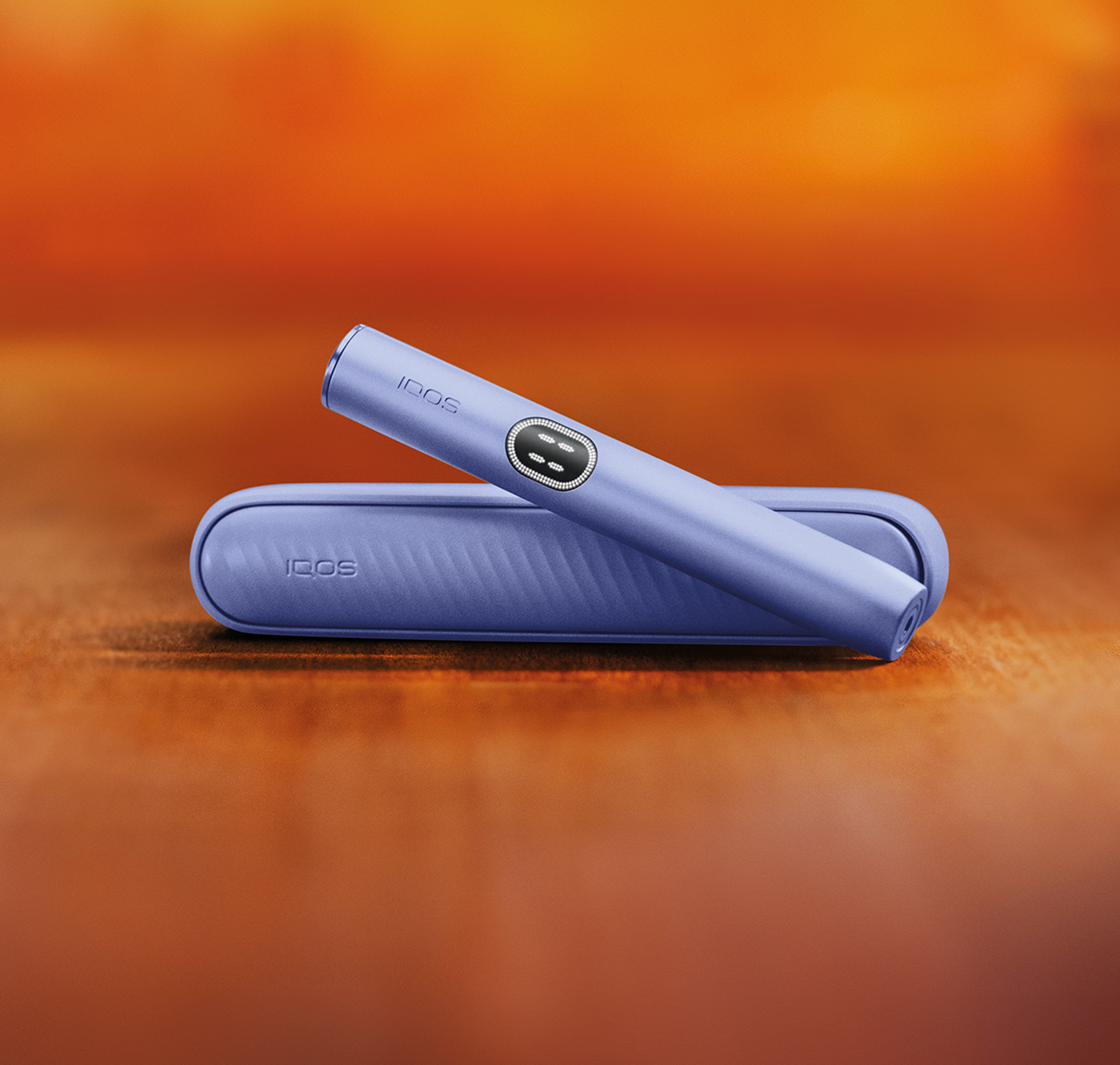 Violet IQOS ILUMA i device above its charger.