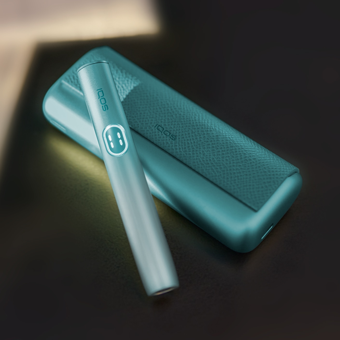 Breeze Blue IQOS ILUMA i PRIME device on its charger