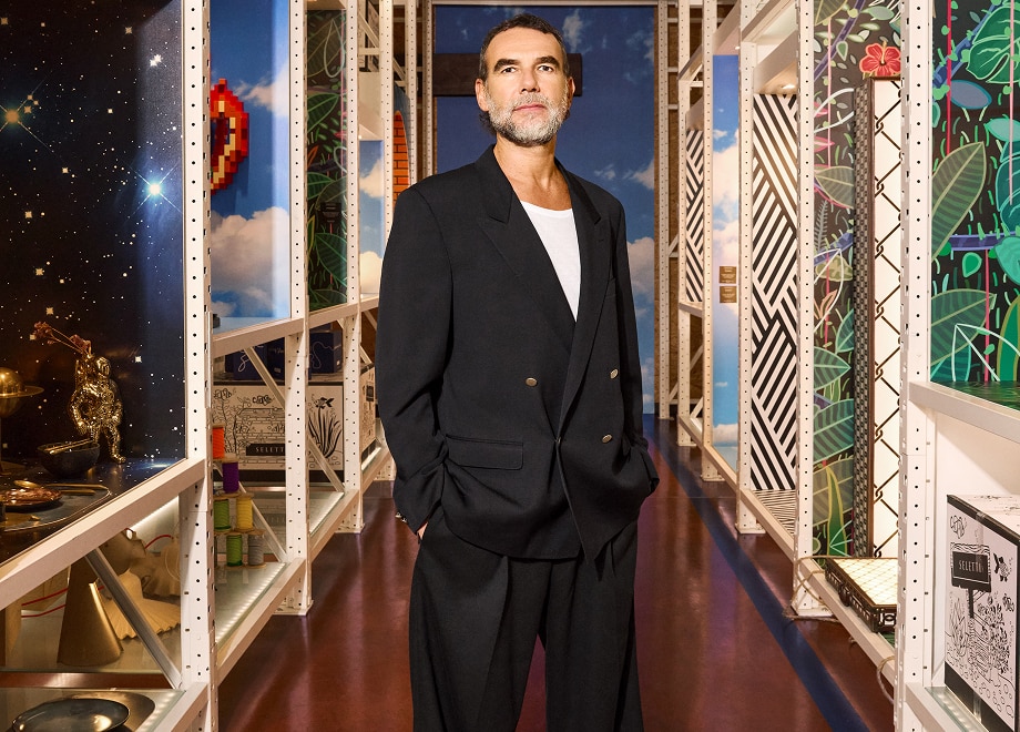 Stefano Seletti standing between two shelves with Seletti design pieces