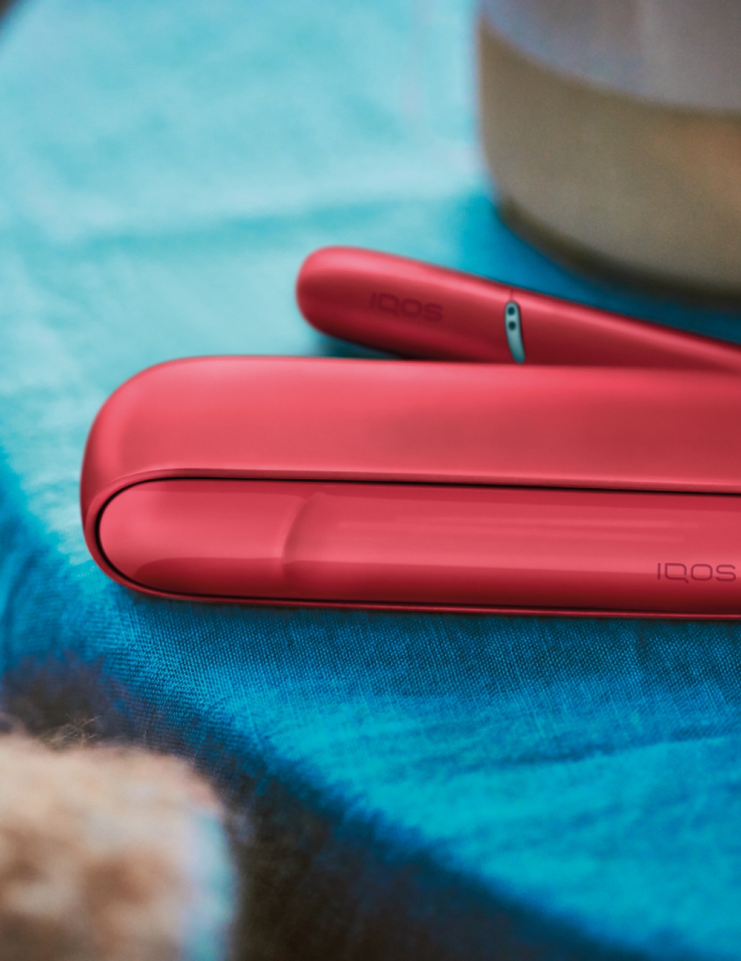 Red IQOS Originals Duo heated tobacco device with case.